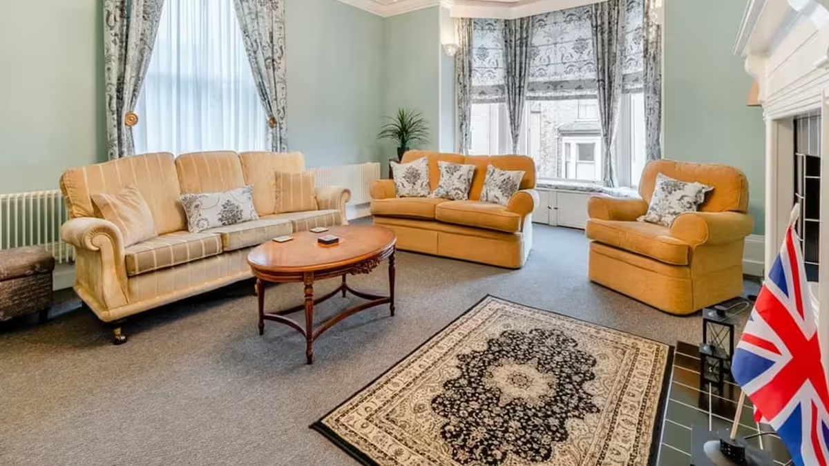 Spacious lounge with three sofas and bay windows